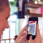 Woman reading a QR code with phone