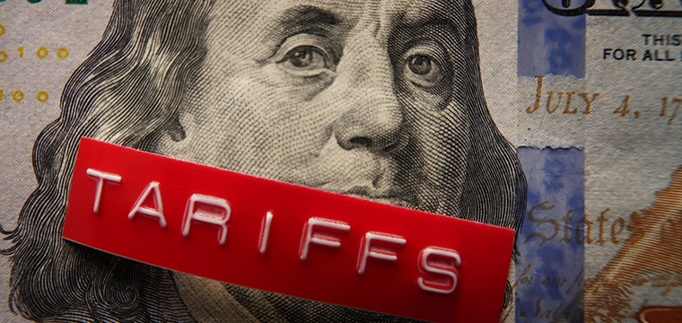 Dollar with tariff sticker on it