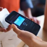 Phone being used at a handheld payment terminal