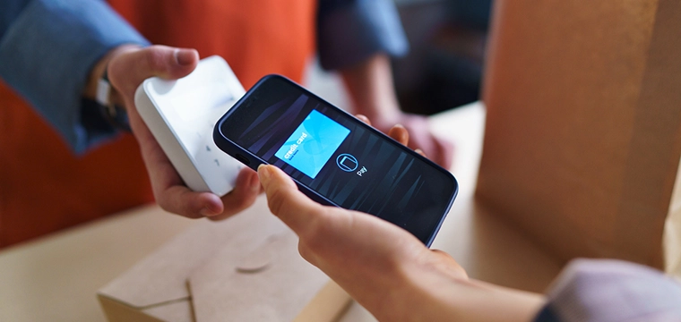 Phone being used at a handheld payment terminal