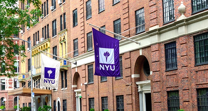 Flags hanging on building at NYU, site for ColorID Identity Summit 2026