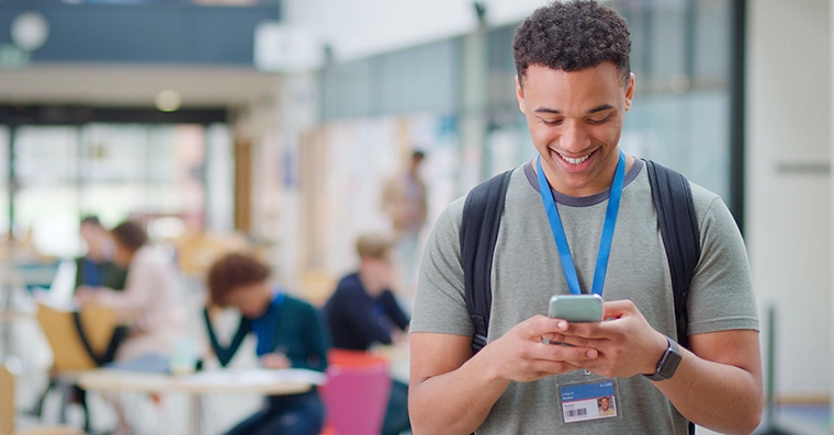 Student with phone and ID card