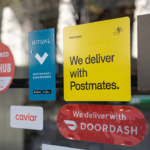 DoorDash and Grubhub stickers on restaurant window