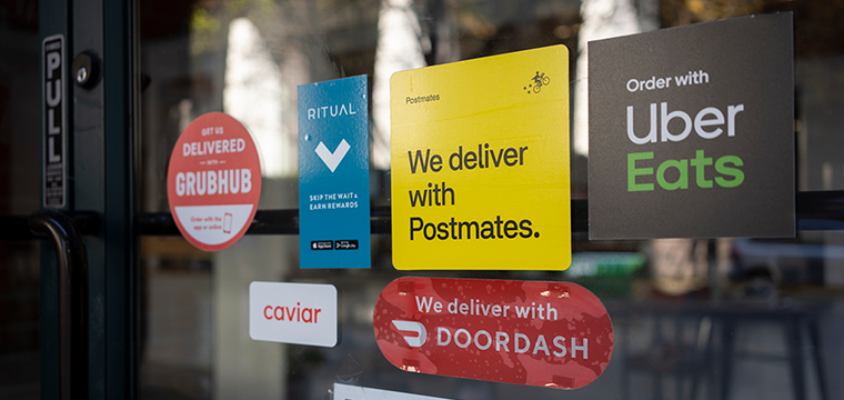 DoorDash and Grubhub stickers on restaurant window